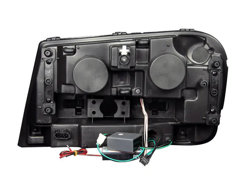 Rear view of Chevrolet Trailblazer projector headlight set with wiring and electronics