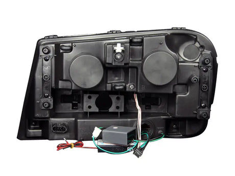 Rear view of Chevrolet Trailblazer projector headlight set with wiring and electronics