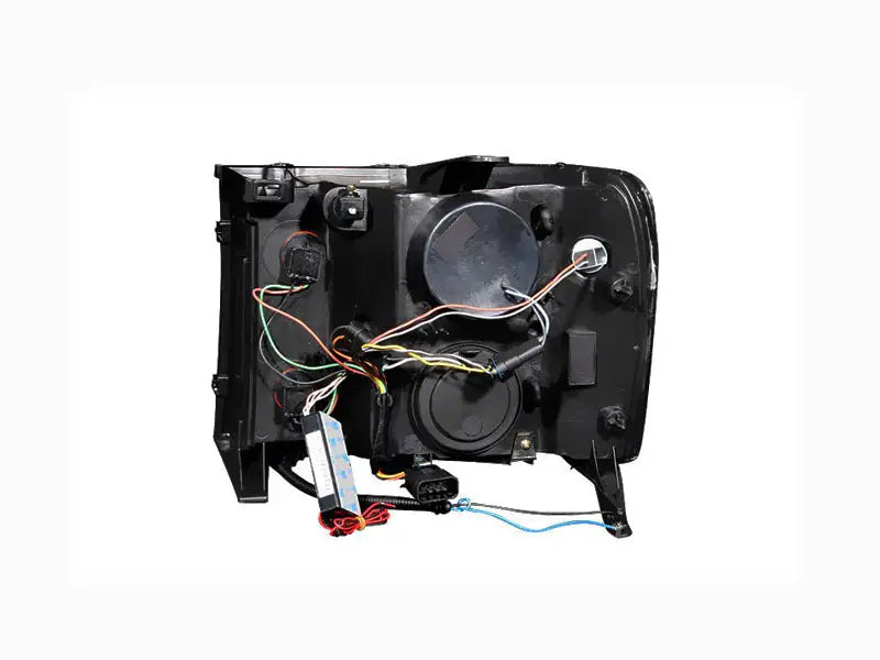 Rear view of GMC Sierra projector headlights with halo chrome and visible wiring and components