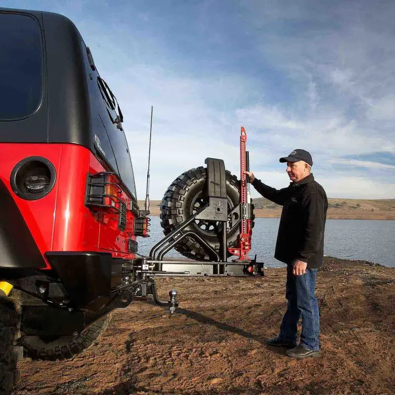 Red off-road jack on ARB Rear Bar Wheel Carrier Tj for tough trail setups