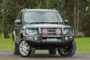 Gray Land Rover with bull bar featuring ARB Summit Combar and ARB Fog for Disco 4