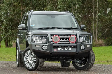 Gray Land Rover with bull bar featuring ARB Summit Combar and ARB Fog for Disco 4