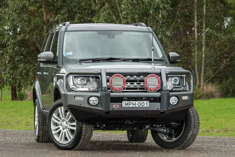 Gray Land Rover with bull bar featuring ARB Summit Combar and ARB Fog for Disco 4