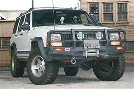 White Jeep Cherokee with aftermarket bumper featuring ARB Winchbar Suit for Jeep XJ Cherokee