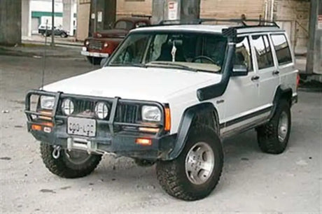 White Jeep Cherokee with off-road mods showcasing ARB Winchbar Suit for Jeep XJ Cherokee