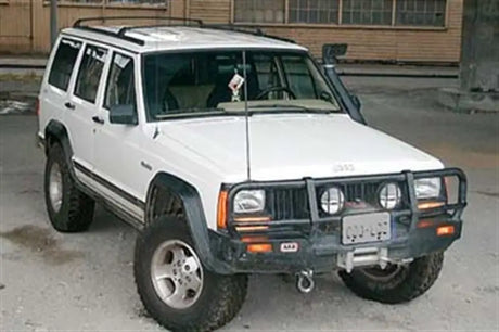 White Jeep Cherokee with off-road mods equipped with ARB Winchbar Suit Srs Jeep XJ Cherokee 84-96