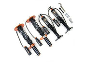 Four black and orange BMW M3 G80 coilovers with reservoirs and tools for better driving experience
