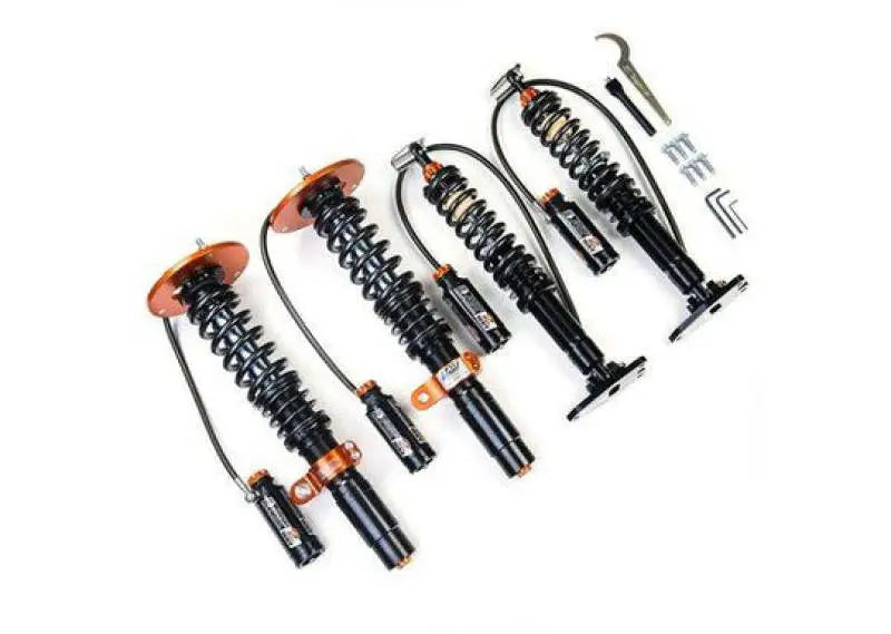Four black and orange AST 5200 Series Coilovers Mazda MX-5 with adjustment tools