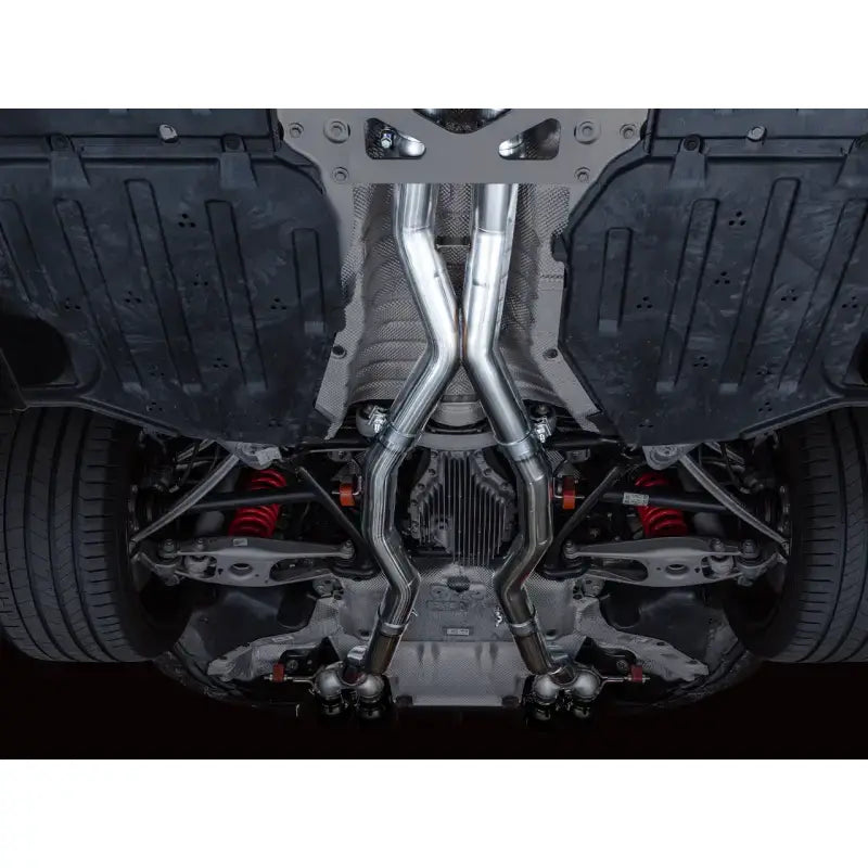 AWE Track Edition Catback Exhaust for BMW G8X M3/M4 with Diamond Black Tips, undercar view showing dual exhaust system.