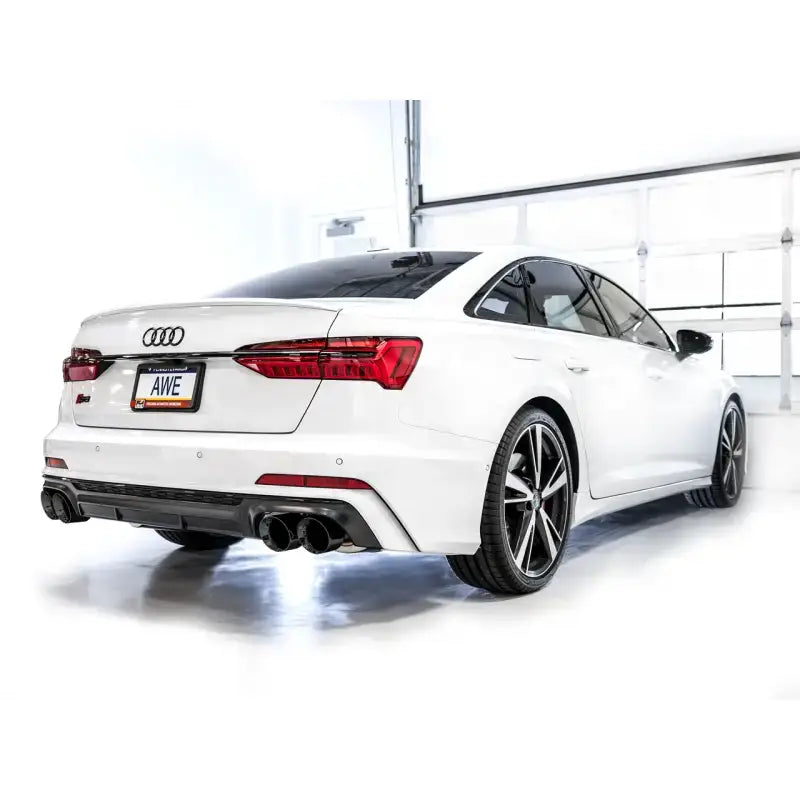 White Audi S6 sedan with AWE Tuning track edition exhaust and Diamond Black Tips