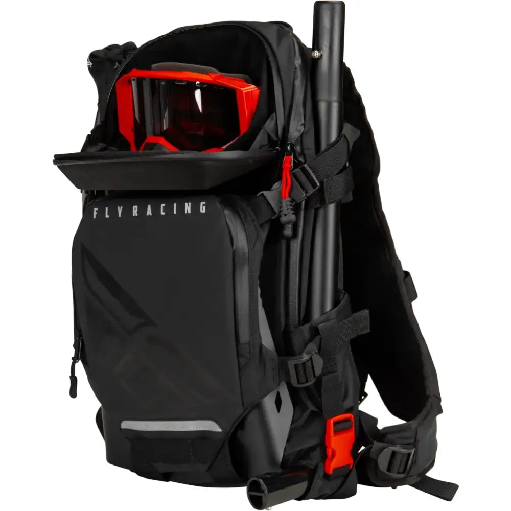 Black Backcountry Pack with shoulder straps, red goggles, and truck parts accessory