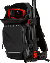 Black Backcountry Pack with shoulder straps, red goggles, and truck parts accessory