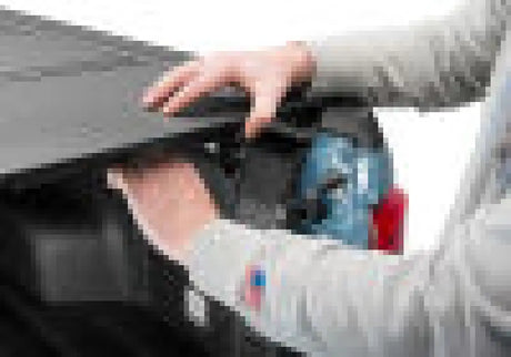 Person adjusting BAK 2022 Ford Maverick 4.5ft BAKFlip MX4 hard folding truck bed cover with a matte finish.