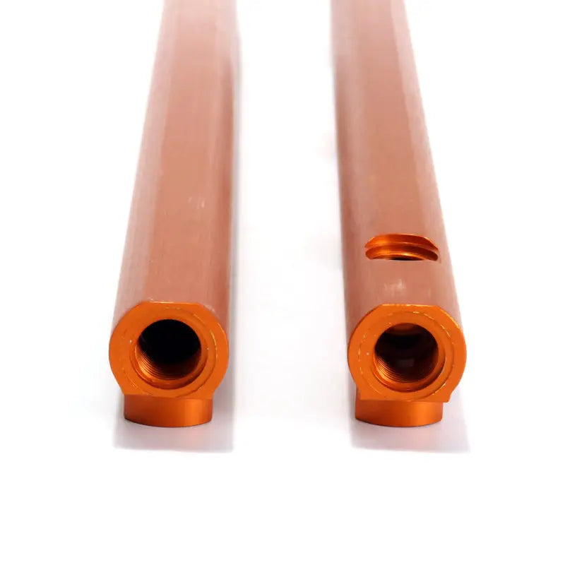 Orange metal fuel rail tubes with threaded ends in BBK high flow billet aluminum rail kit