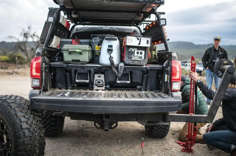 Truck bed with storage boxes and camping gear showing the Bed Drawer with high load capacity