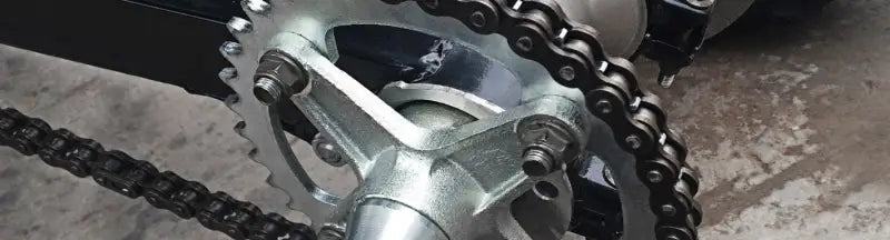 Silver sprocket with chain for Honda rear steel sprocket replacement on BikeMaster Honda Rear Steel Sprocket 520 39T Black