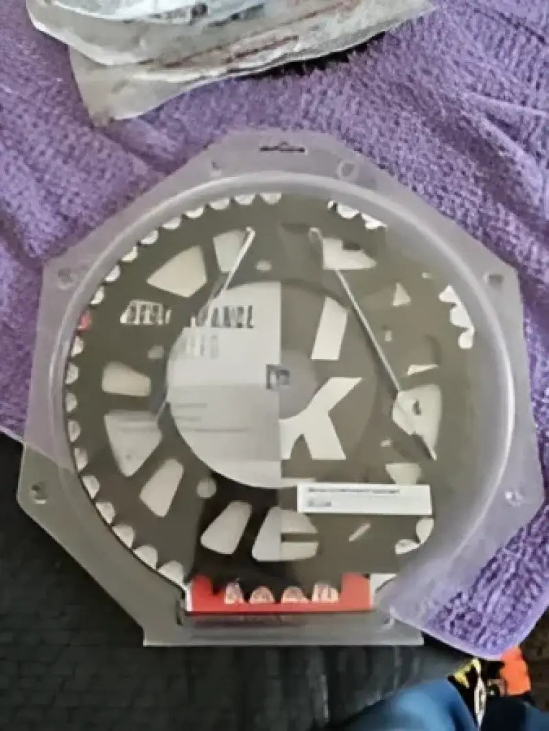 Motorcycle rear sprocket in packaging for BikeMaster Kawasaki Rear Steel Sprocket 520 49T