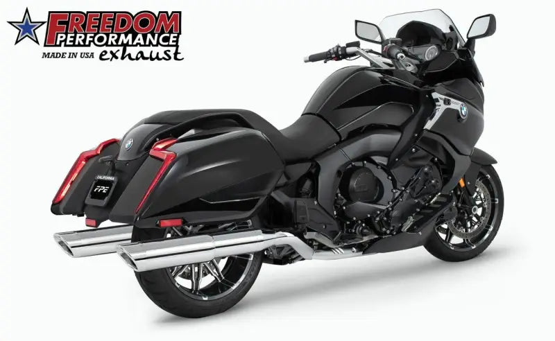 Black touring motorcycle with chrome slip-on exhaust and saddlebags for truck parts
