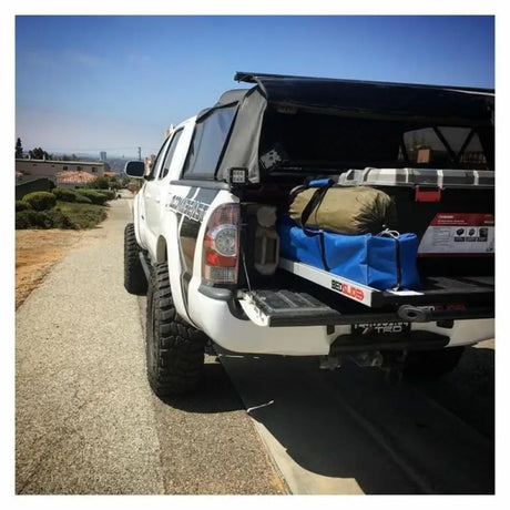 White pickup truck with bed slide showcasing Ecoological Textured Black TPO bumper overlay
