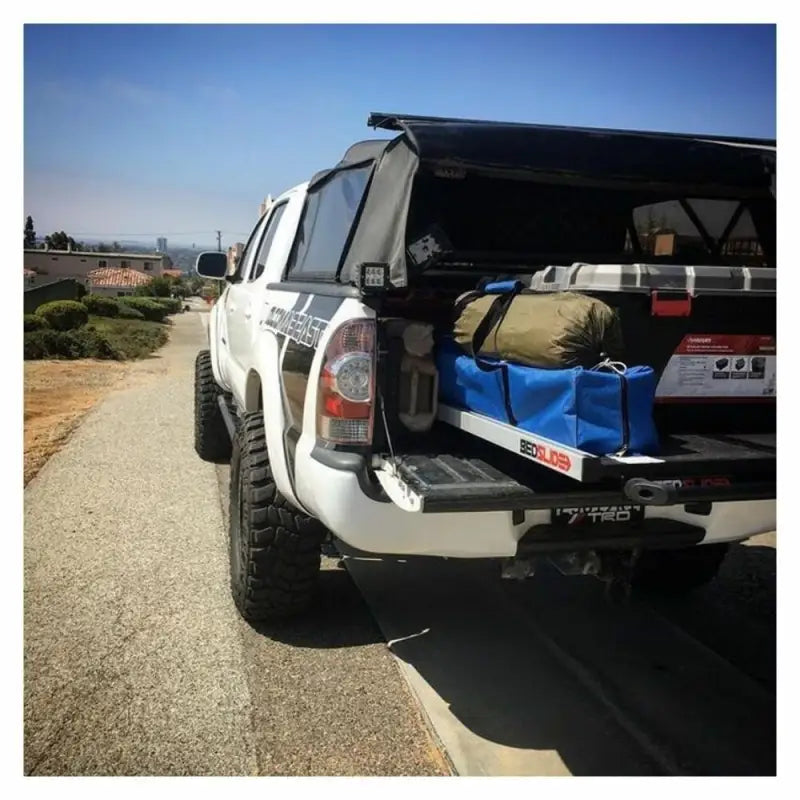 White pickup truck with bed slide showcasing Ecoological Textured Black TPO bumper overlay