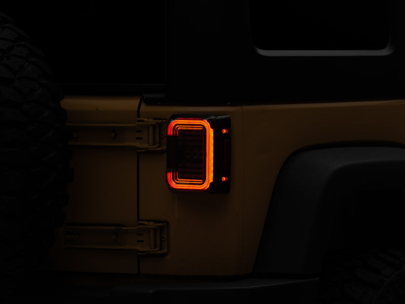 Raxiom J138358 Raxiom 07-18 Jeep Wrangler JK Axial Series LED Halo Tail Lights- Black Housing (Dark Smoked Lens)