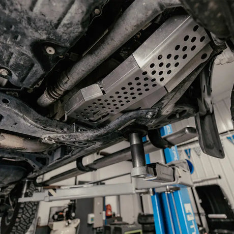 Underside of Toyota Tacoma with Cali Raised catalytic converter shield installed for protection
