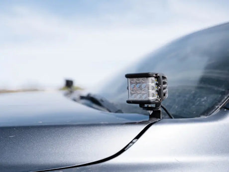 Cali Raised black LED low profile ditch light bar on Toyota Tacoma hood