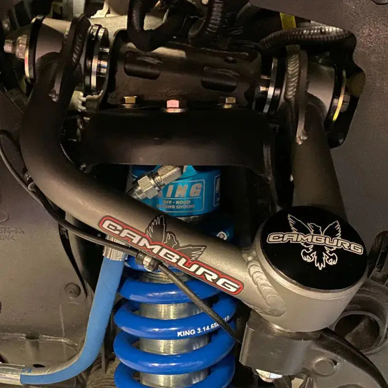  Camburg Ford F-150 2WD/4WD 21-23 1.25in Performance Uniball Upper Arms with covers installed, featuring enhanced suspension components and King Off-Road Racing Shocks for improved handling and durability.