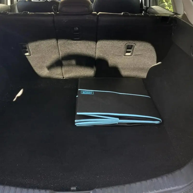 Collapsible black polyester cargo organizer, single compartment, in the cargo area of an SUV, folded flat for easy storage, measuring 40.75 inches in length, 21 inches in depth, and 10 inches in height, with a 5 cubic foot capacity.