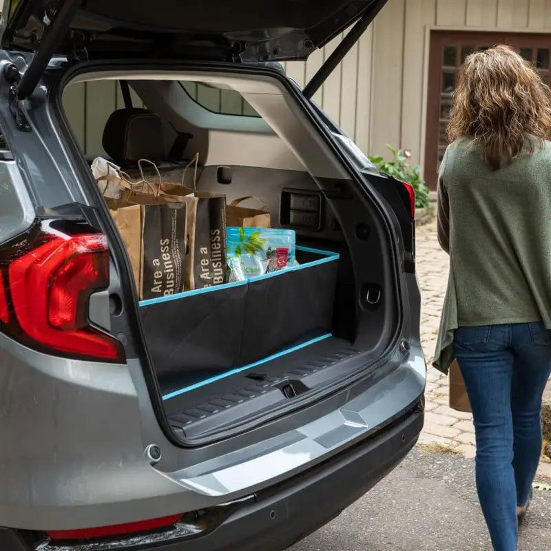 Cargo Organizer in the cargo area of an SUV filled with grocery bags, single compartment, collapsible, black polyester, dimensions 40.75 x 21 x 10 inches, 5 cubic foot capacity.