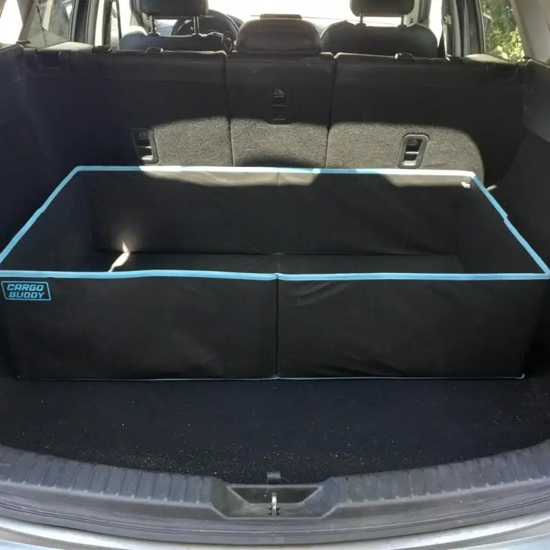 Cargo Buddy black polyester collapsible single compartment cargo organizer in the cargo area of an SUV or truck, measuring 40.75 inches in length, 21 inches in depth, and 10 inches in height, with a 5 cubic foot capacity.