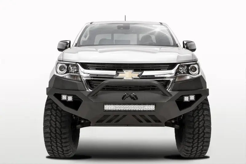 White Chevrolet truck equipped with Fab Fours Vengeance Front Bumper Pre-Runner Guard in black, designed for maximum protection and enhanced rugged appearance.