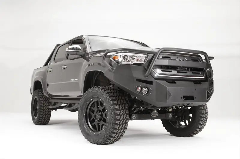Fab Fours Vengeance Front Bumper Pre-Runner Guard in 15 Color installed on a lifted off-road vehicle, showcasing its rugged design and high-quality construction.