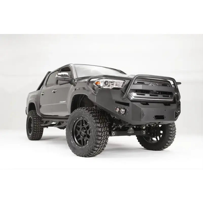 Fab Fours Vengeance Front Bumper Pre-Runner Guard in 15 Color installed on a lifted off-road vehicle, showcasing its rugged design and high-quality construction.