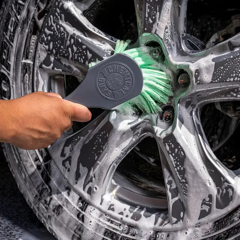 Soapy car wheel being cleaned with Chemical Guys Wheelie Wheel & Tire Brush