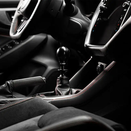 Stylish black car interior featuring COBB Subaru 6-Speed Weighted Knob and collars