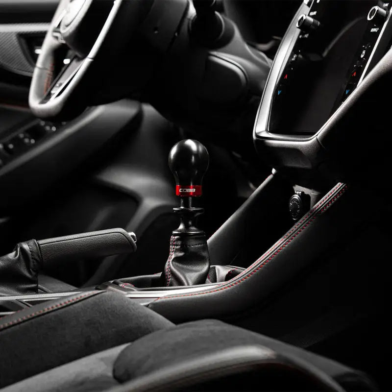 Black gear shift knob with red accent from Cobb Subaru’s 6-Speed Weighted Knob