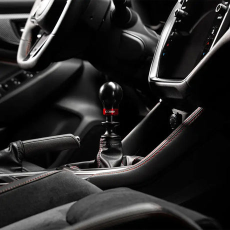 Black gear shift knob with red accent from Cobb Subaru’s 6-Speed Weighted Knob