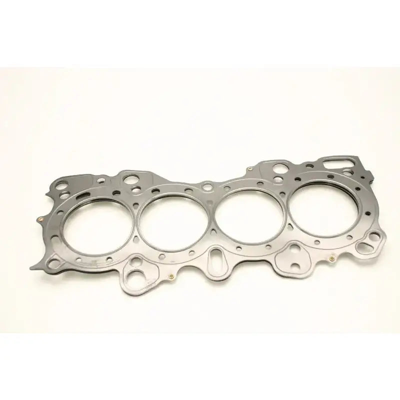A Cometic Gasket Honda CRX/Civic/Integra - VTEC 81mm .030 inch MLS Head Gasket, featuring four round cylinder openings and multiple bolt holes, is showcased against a plain white background. This intricately shaped gasket is designed to fit over the engine block's cylinders and maintain a perfect seal.