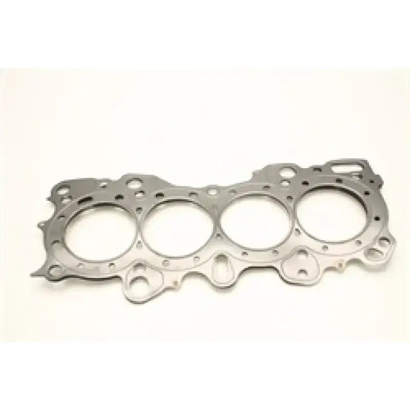 The Cometic Honda CRX/Civic/Integra VTEC 81mm .030 inch MLS Head Gasket by Cometic Gasket is displayed against a white background, featuring four large circular openings for the VTEC 81mm engine. This metallic gasket is compatible with Honda CRX, Civic, and Integra models and includes multiple smaller holes within its complex, irregular outer shape.