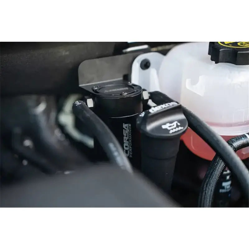 CORSA Performance Aluminum Oil Catch Can w/ Bracket installed in a Silverado engine bay.