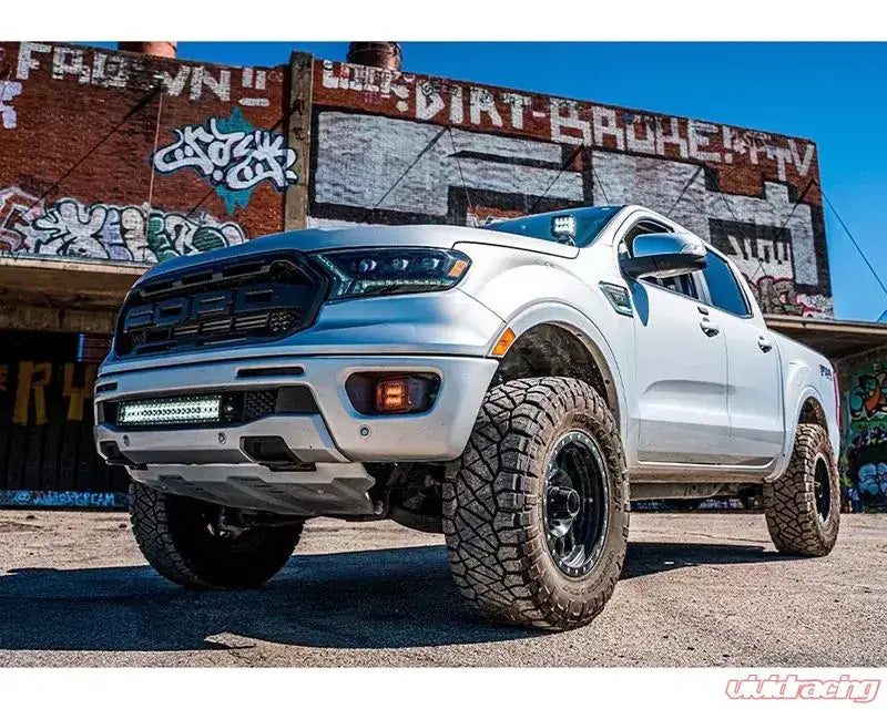 Silver Ford Ranger pickup truck with Cali Raised fog mounts for 2019+ models