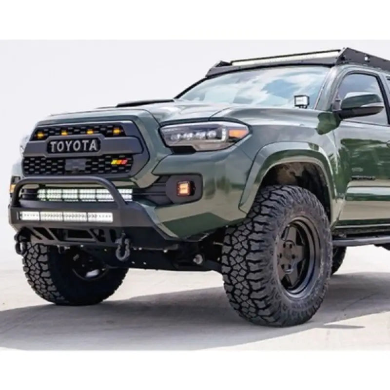 Green Toyota Tacoma with off-road mods and CR3384 Cali Raised Stealth Bumper