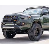 Green Toyota Tacoma with off-road mods and CR3384 Cali Raised Stealth Bumper