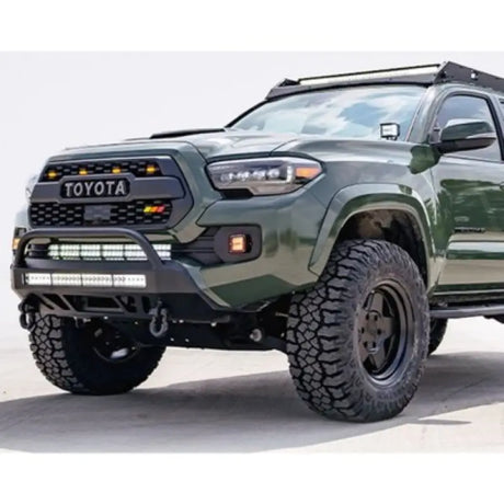Green Toyota Tacoma with off-road mods and CR3384 Cali Raised Stealth Bumper
