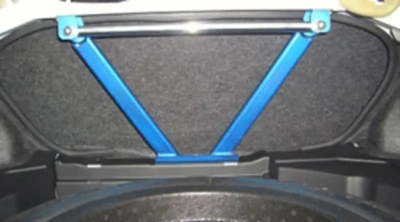 Blue Cusco Power Brace rear in car trunk for enhanced stability and performance