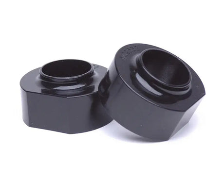 Two black coil spring lift spacers for Jeep Cherokee XJ 2&4WD, perfect for upgrades
