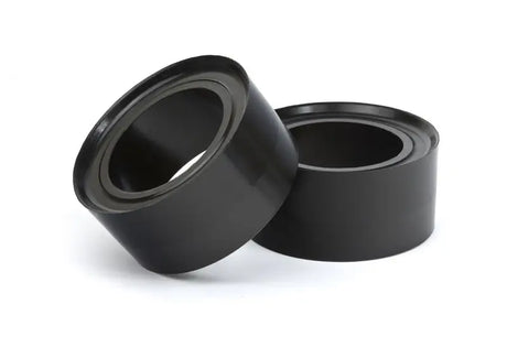 Two black cylindrical bushings for Daystar 1996-2002 Toyota 4Runner leveling kit