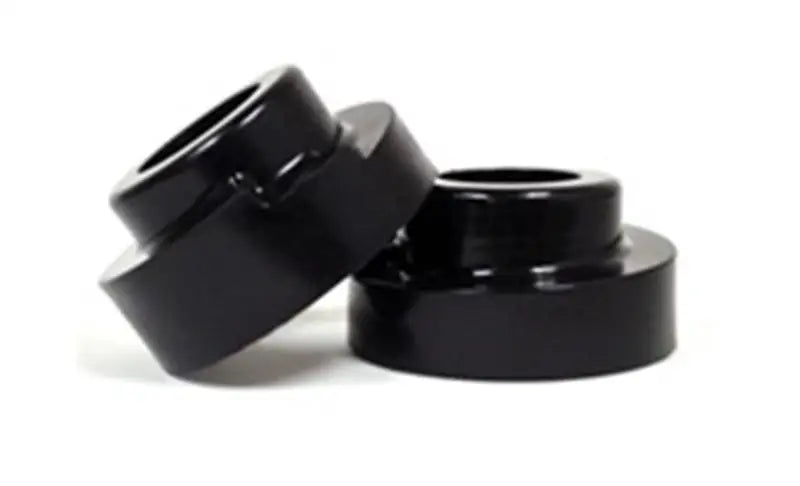 Black cylindrical lift spacers for Ford F-250 4WD leveling kit upgrade
