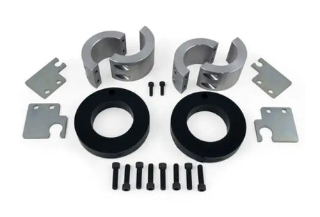 Daystar 2014-2020 Jeep Grand Cherokee 2.0 Inch Lift Kit components with front and rear lift spacers, screws, and metal plates laid out.
